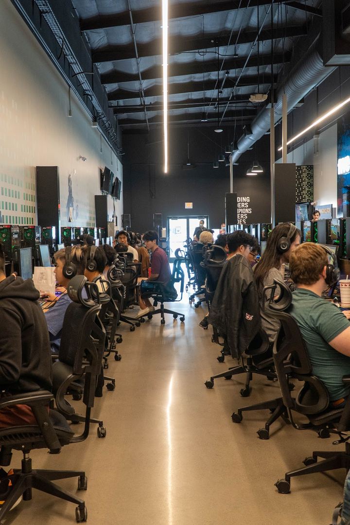Rows of players at their PCs down the length of the room