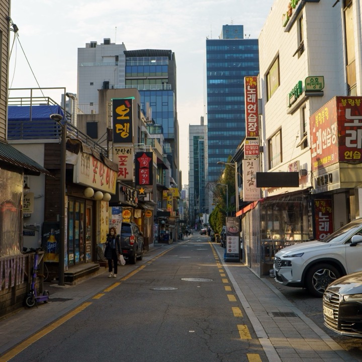 A Seoul street lined with shops and tall towers