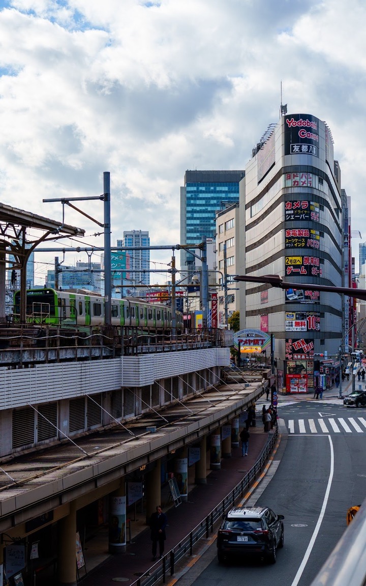Train tracks and office towers in Tokyo seen from an overpass