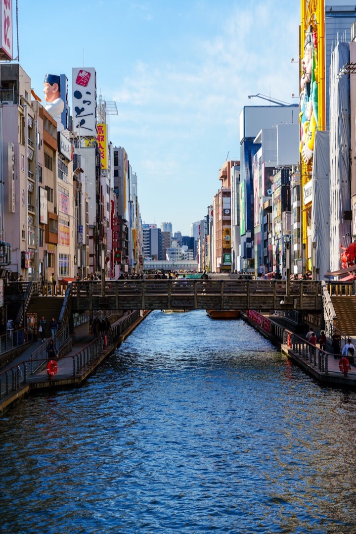 The Dotonbori canal in Osaka between signs and storefronts