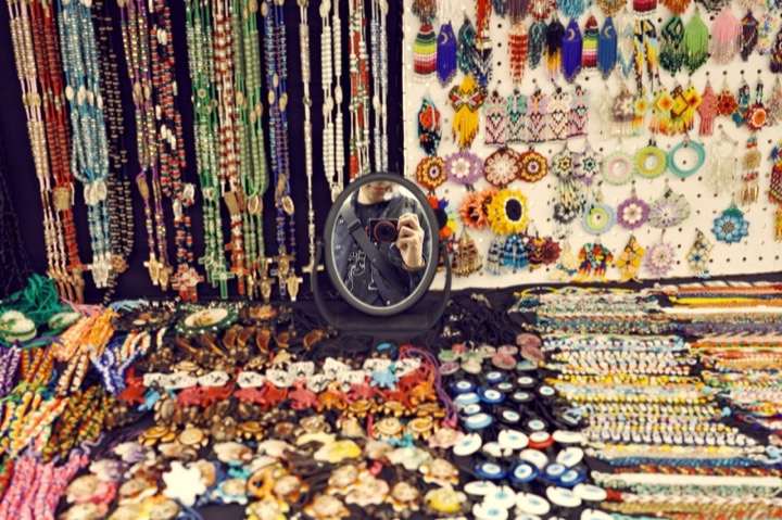 A market stall covered in beaded jewelry